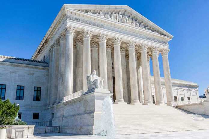 Supreme Court building with columns, fountain, and statue.