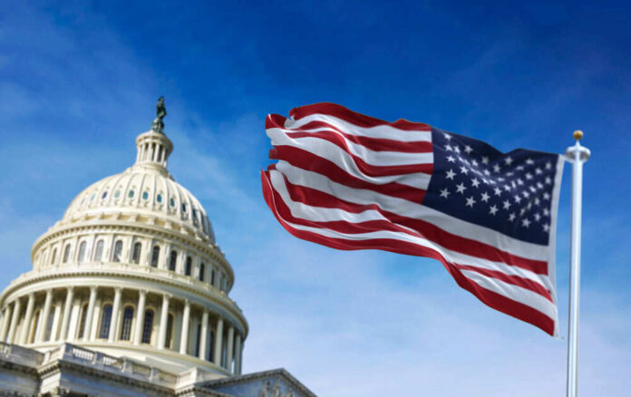 U.S. Capitol building with American flag waving.