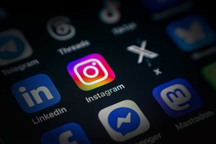 Close-up of a smartphone screen displaying various social media app icons, including Instagram