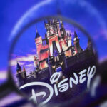 SHOCKING Disney Death Rocks Florida Resort Magnifying glass focusing on Disney castle logo.