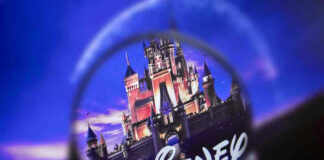Magnifying glass focusing on Disney castle logo.