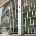 Child Torture Horror: Woman Killer Faces Life Empty prison cell with metal bars and toilet.