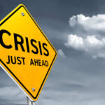 Popular Restaurant Franchisee COLLAPSES — Thousands of Jobs in Peril A yellow warning sign indicating a crisis ahead