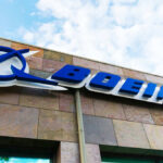 Boeing’s Fatal Oversight: 15 Lives Lost Boeing logo on building with cloudy sky background