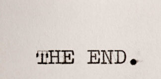 Typewritten text reading 'THE END.' on a sheet of paper