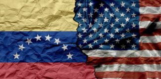 Crumpled flags of Venezuela and the United States split in the center