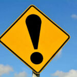 Brutal Crash Can’t Stop Her! Yellow caution sign with exclamation mark symbol.