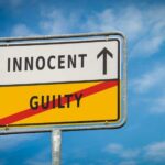 INNOCENT Men IMPRISONED — Real Killer Dead A road sign displaying 'INNOCENT' with an arrow pointing up and 'GUILTY' crossed out