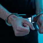 Thousands Arrested — Trump Pulls Plug Close-up of hands in handcuffs