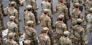 A formation of soldiers in military uniforms marching in a parade