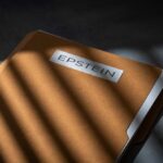 Elite Billionaire CAUGHT in Epstein Files A brown folder with the name 'EPSTEIN' on it, partially illuminated by light and casting shadows