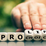 Hand shifting blocks spelling pro life to pro choice