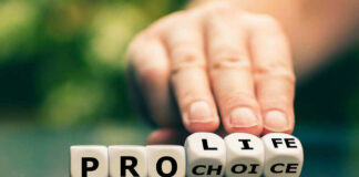 Hand shifting blocks spelling pro life to pro choice