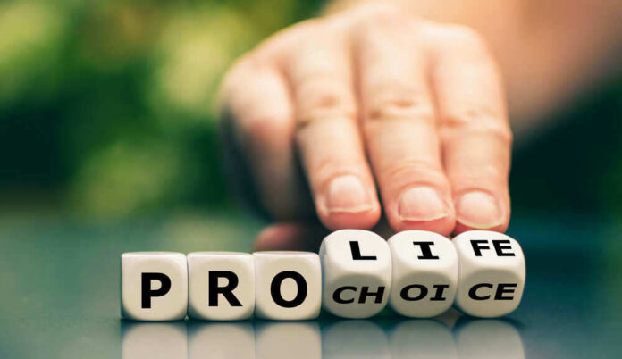 Hand shifting blocks spelling pro life to pro choice