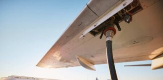 Fueling an aircraft at the airport with a hose connected to the wing