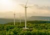 Wind turbines on a hillside during sunset