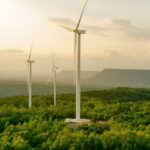 Wind turbines on a hillside during sunset