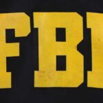FBI Leak Probe Hits Trump Counterterrorism Chief FBI logo displayed in large yellow letters on a black background