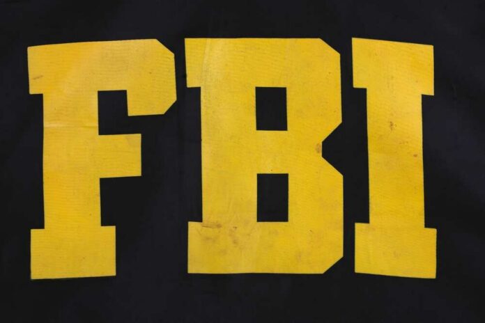 shutterstock_2220332053.jpg FBI logo displayed in large yellow letters on a black background