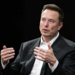 Musk Bombshell Shocks Silicon Valley Elon Musk speaking and gesturing with hands in discussion.