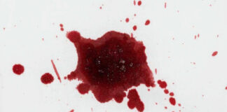 Red liquid splatter on a white background.