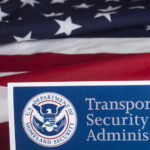 Massive TSA Exodus: 300 Quit Transportation Security Administration sign in front of an American flag