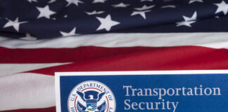 Transportation Security Administration sign in front of an American flag