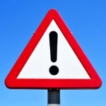 Pipe-Bomb Scare Shuts Park Near D.C. A triangular warning sign with an exclamation mark against a blue sky