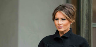 Melania Trump in black coat.