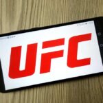 Smartphone displaying the UFC logo on a wooden surface