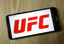 Smartphone displaying the UFC logo on a wooden surface