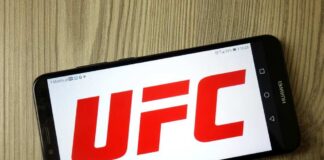 Smartphone displaying the UFC logo on a wooden surface