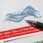 Trump SLAMS Mail-In Fraud — Democrats Racing to Court Vote-by-mail envelope with pen on top.
