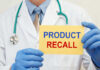 RECALL ALERT: 3 Million Impacted Nationwide Doctor holding a product recall sign in gloves