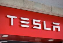 Tesla logo displayed on a red background
