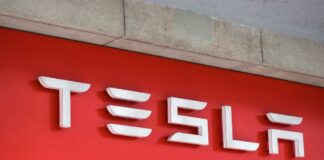 Tesla logo displayed on a red background