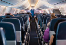 Airplane interior with passengers seated mid-flight.