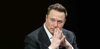 Elon Musk in suit thinking.