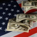 Dollar bills arranged on an American flag