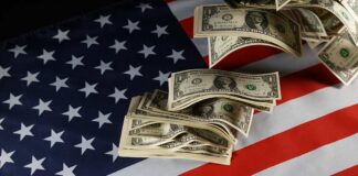 Dollar bills arranged on an American flag