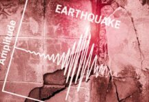 Seismograph showing earthquake amplitude on a cracked wall