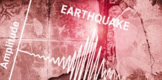 Seismograph showing earthquake amplitude on a cracked wall