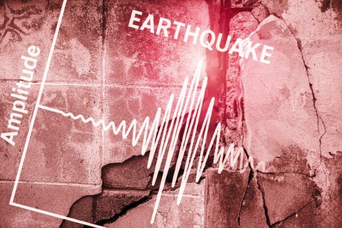 Seismograph showing earthquake amplitude on a cracked wall