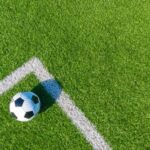 96-Year Soccer Tradition DESTROYED? A soccer ball resting on a green artificial turf field near the corner