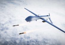 Military drone releasing missiles in the sky