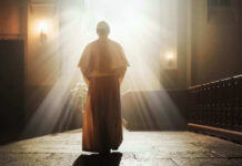 SHOCK Apology: Church’s Slavery Role Exposed Person in religious attire bathed in sunlight.