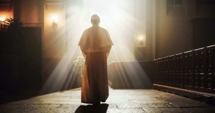 shutterstock_2253549751 Person in religious attire bathed in sunlight.