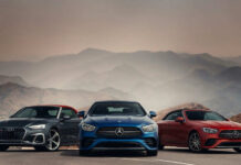 EV Debut Tanks Stock — Billions Vanish! Three luxury cars in front of mountain landscape
