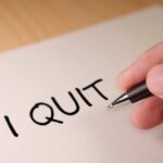 He QUITS After White House Heat A hand writing 'I QUIT' on a piece of paper