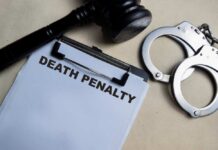 A gavel, handcuffs, and a document titled 'DEATH PENALTY'